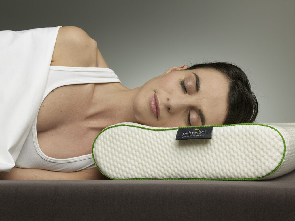 a woman sleeps on her side on a custom made pillow